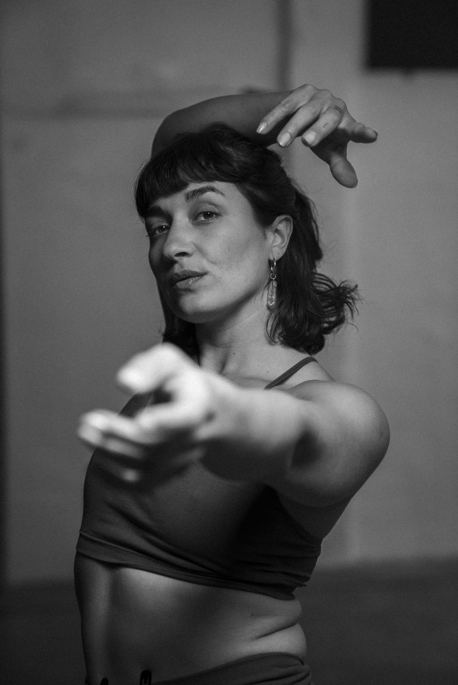 Anita reaching one hand out toward the camera, black and white